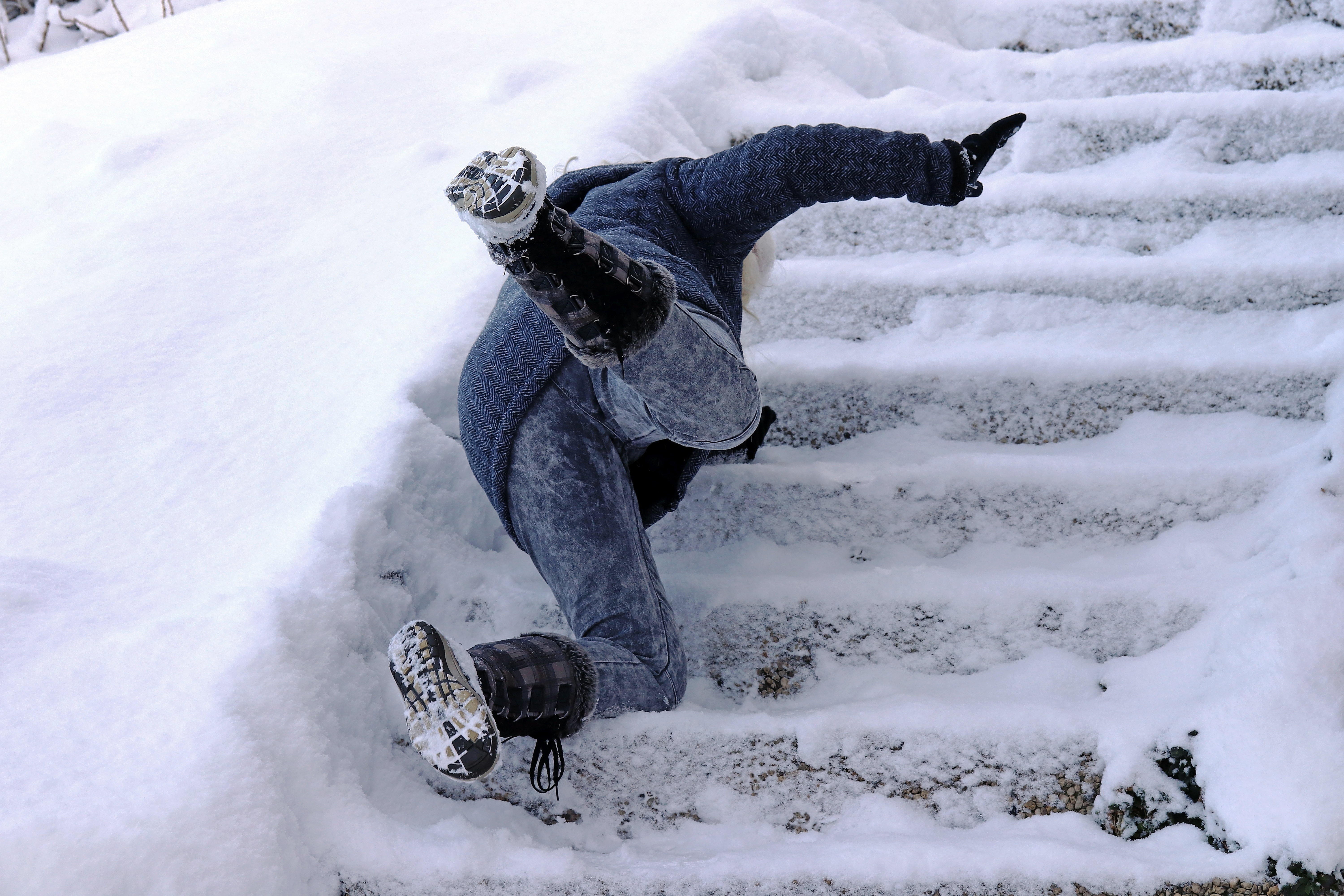 A woman slips and fell on a wintry staircase. Fall on smooth steps